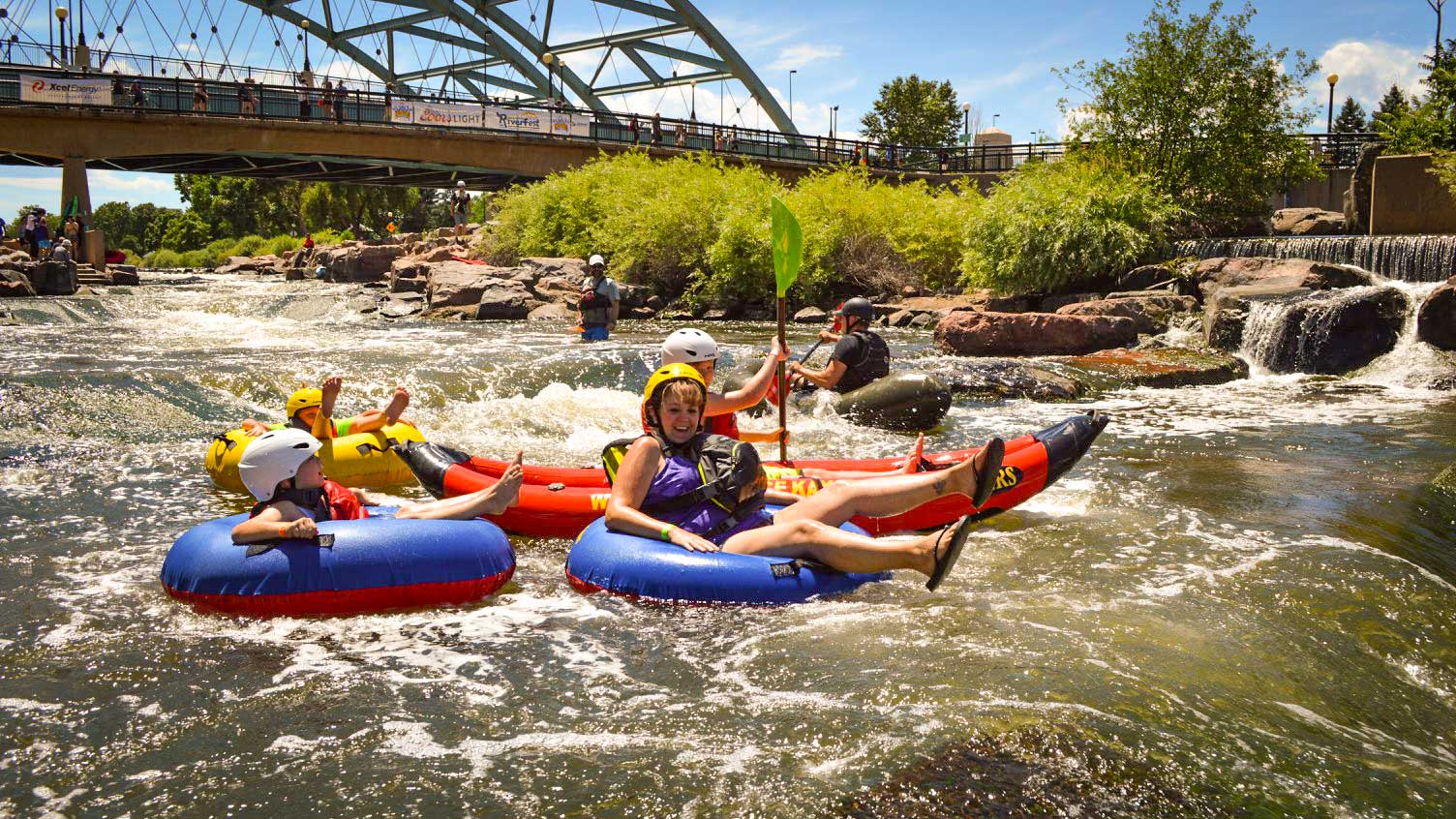 Attendees at CROSSCURRENTS float down the South Platte River in Confluence Park