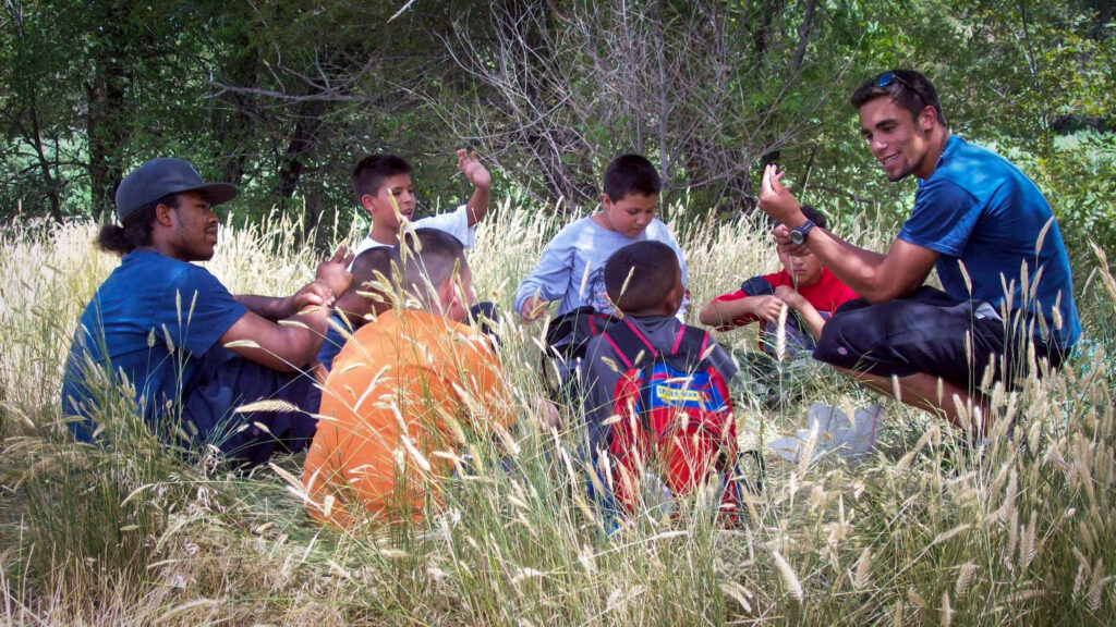 Greenway River Ranger leads a group of campers in an activity along the South Platte River