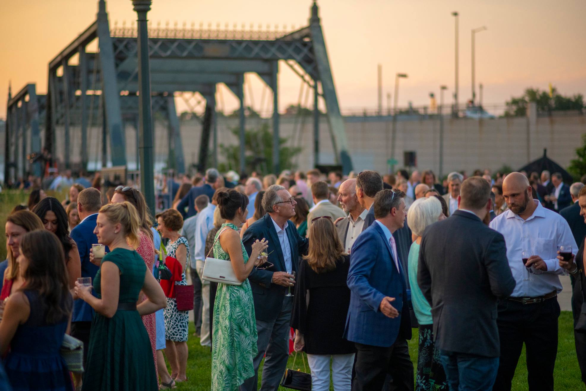 Guests at Gala on the Bridge enjoy the beautiful park atmosphere by the historic 19th Street Bridge.
