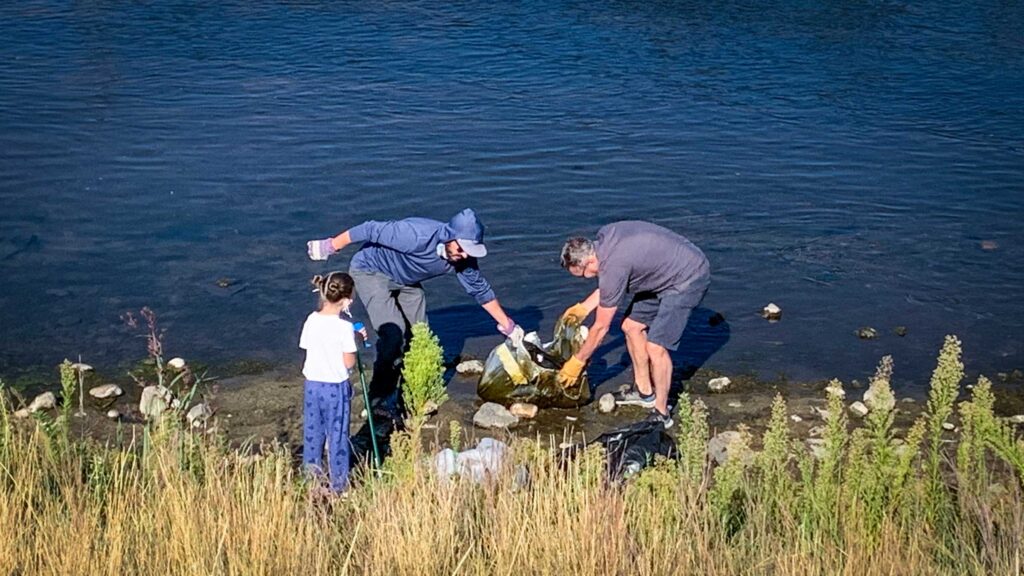 A family removes litter from the South Platte River during Spring Family Stewardship Day